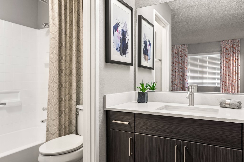 a bathroom with a toilet sink and bathtub in a 555 waverly unit